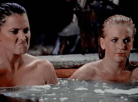 Scene from the show Xena: Warrior Princess where Xena and Gabrielle splash each other in the bath