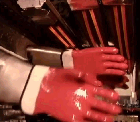 Clip of hand molds spinning in a rubber glove production line