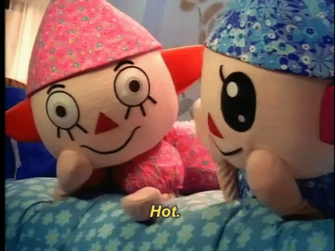 Scene from a commercial for Animal Crossing where costumed player character mascots high five
