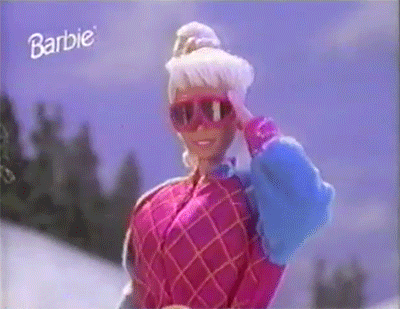 Scene from a commercial where a Barbie doll throws a snowball at the camera